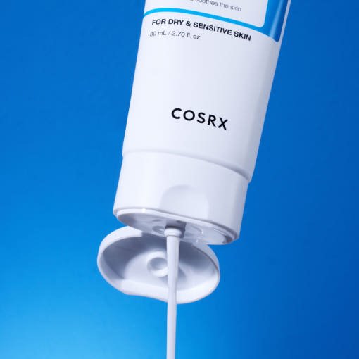 White tube of moisturizing cream dispensing against vibrant blue background highlighting hydration and skin barrier support