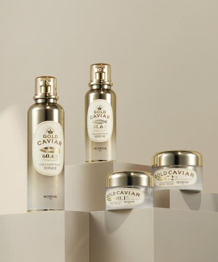 Set of gold and white collagen skincare bottles and jars featuring hydration-boosting formulas on beige podiums