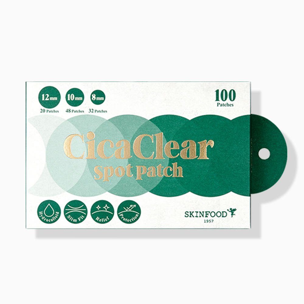 Green and white box of ultra-thin spot patches in three sizes with gold lettering and simple icon graphics