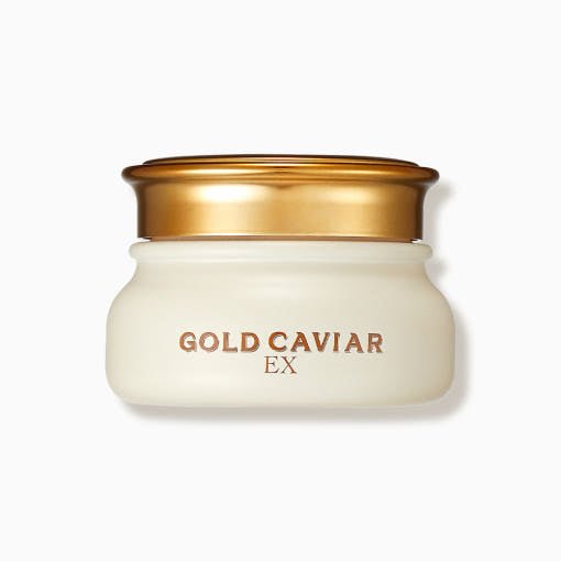 Cream jar with gold lid labeled Gold Caviar EX for radiant complexion, in frosted white glass container