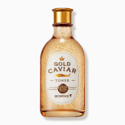 Transparent amber bottle of firming toner with gold flakes and a gold cap on white background