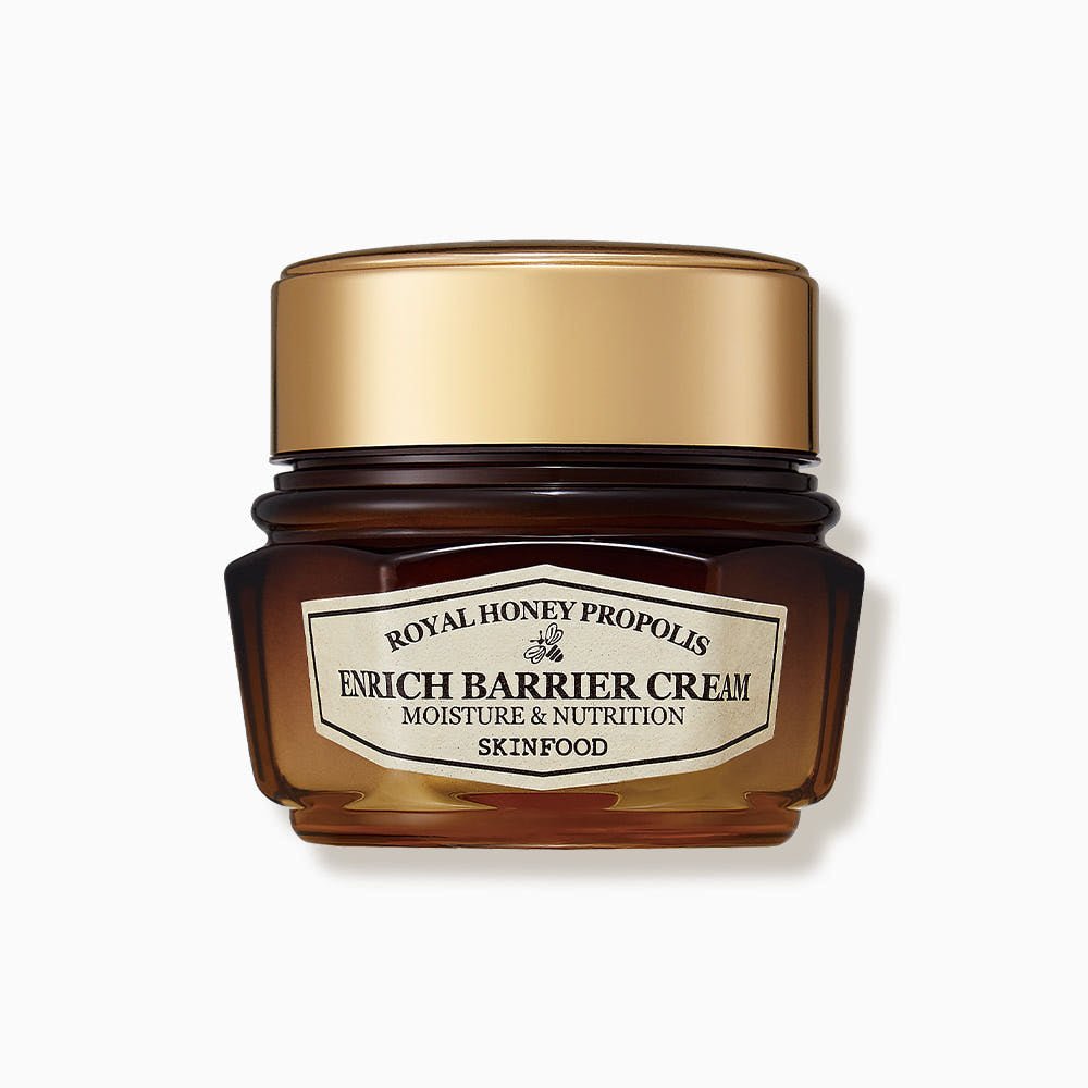 Amber glass jar of nourishing barrier cream with gold lid labeled for moisture and nutrition benefits