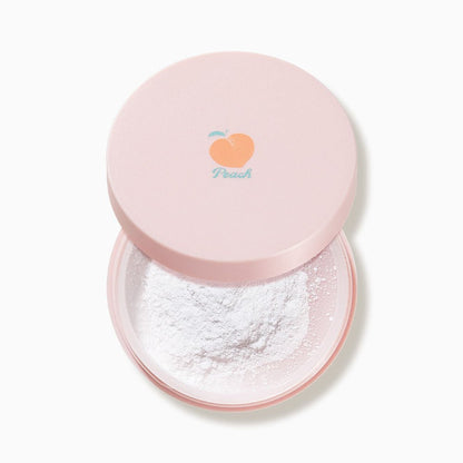 Open pink compact with white loose powder and a small peach illustration on the lid