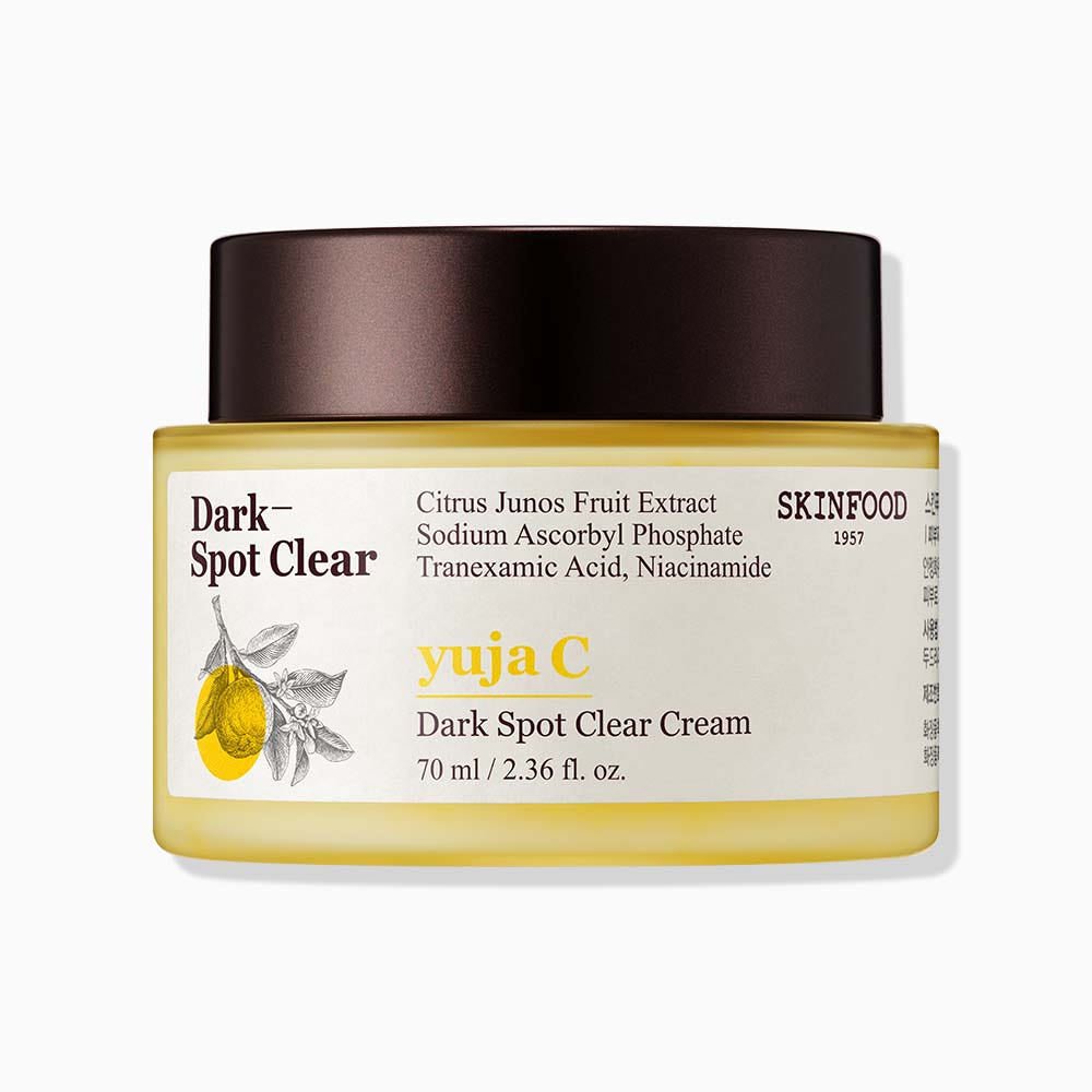 Jar of skincare cream with dark spot reduction ingredients and yellow and brown minimalist label design