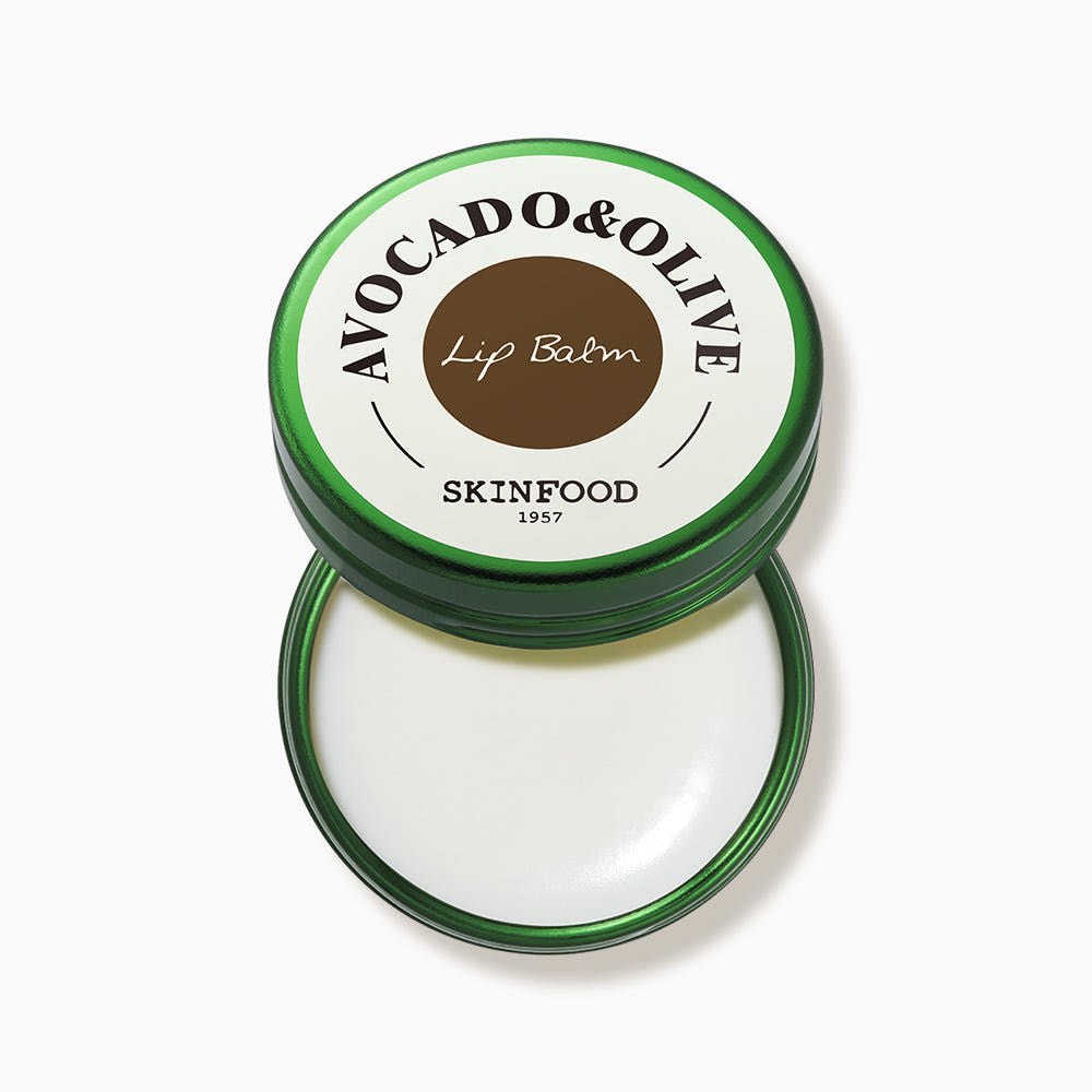 Round green tin of moisturizing avocado and olive lip balm with white balm inside and simple label on lid