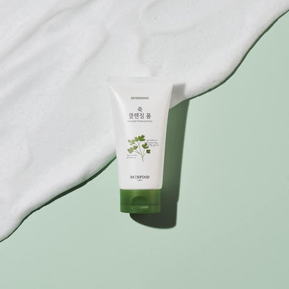 Tube of refreshing cleansing foam with green cap and parsley illustration on soft green background with white foam texture