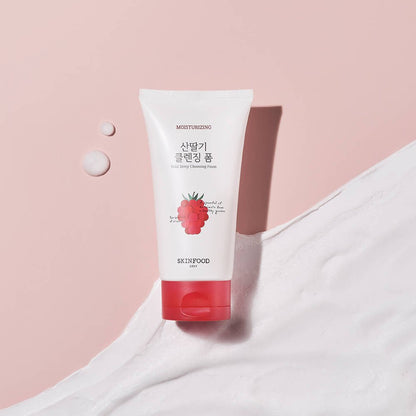 Tube of moisturizing cleansing foam with red berry illustration on soft pink background and creamy foam texture nearby