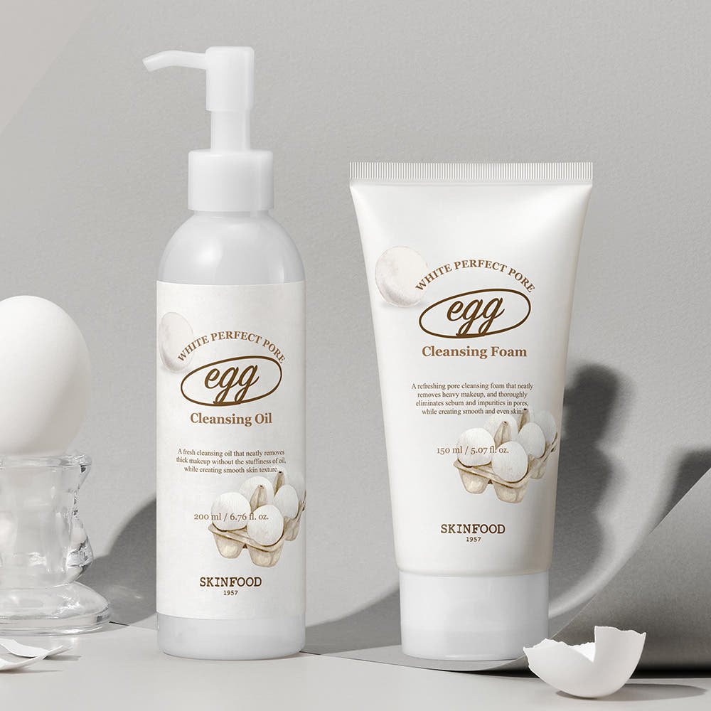 Bottle of pore-cleansing oil and tube of foaming cleanser with smooth white packaging and egg illustrations on light background