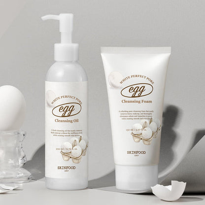 Bottle of pore-cleansing oil and tube of foaming cleanser with smooth white packaging and egg illustrations on light background