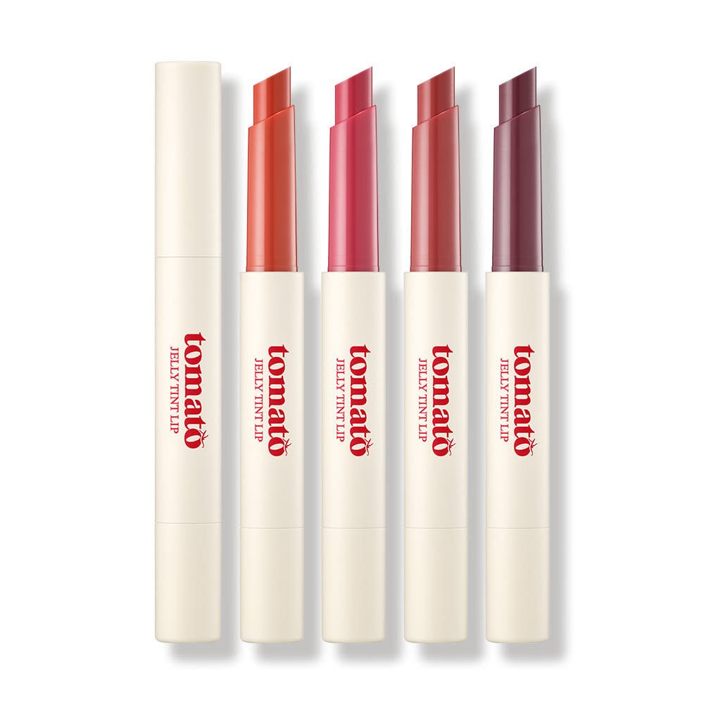 Five shades of tomato jelly tint lipsticks in slim beige tubes with angled tips for smooth, hydrating application