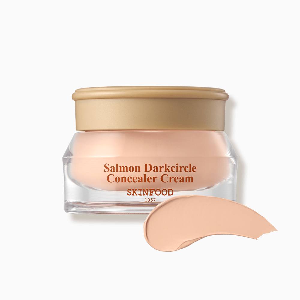 SKINFOOD Salmon Dark Circle Concealer Cream 10g in clear jar with beige lid and smooth creamy swatch for brightening effect