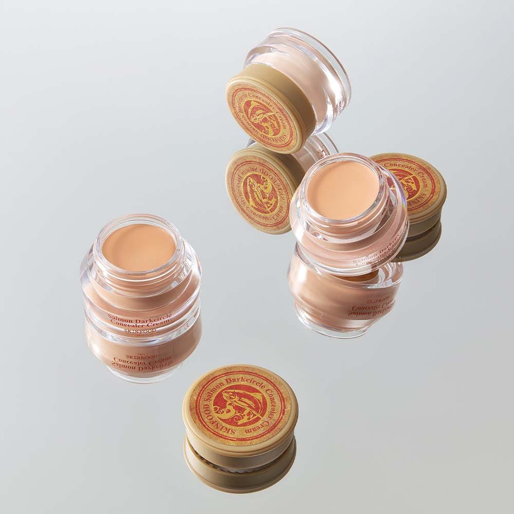 SKINFOOD Salmon Dark Circle Concealer Cream 10g in clear jars with beige cream and gold lids for brightening effect