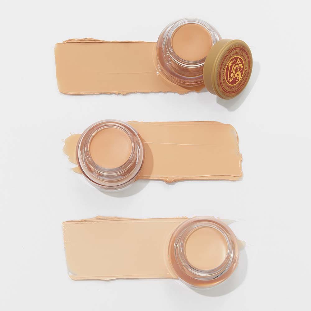 SKINFOOD Salmon Dark Circle Concealer Cream 10g jars with swatches showcasing brightening effect in neutral beige tones