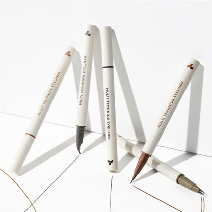 Five sleek white eyeliner pens with different tip styles arranged on white surface casting soft shadows