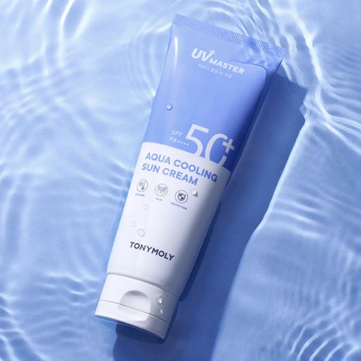 Blue and white tube of cooling sun cream with SPF50+ resting on rippled water surface
