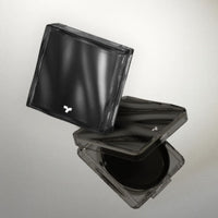 Compact cushion foundation case with sleek black design and subtle logo on reflective surface