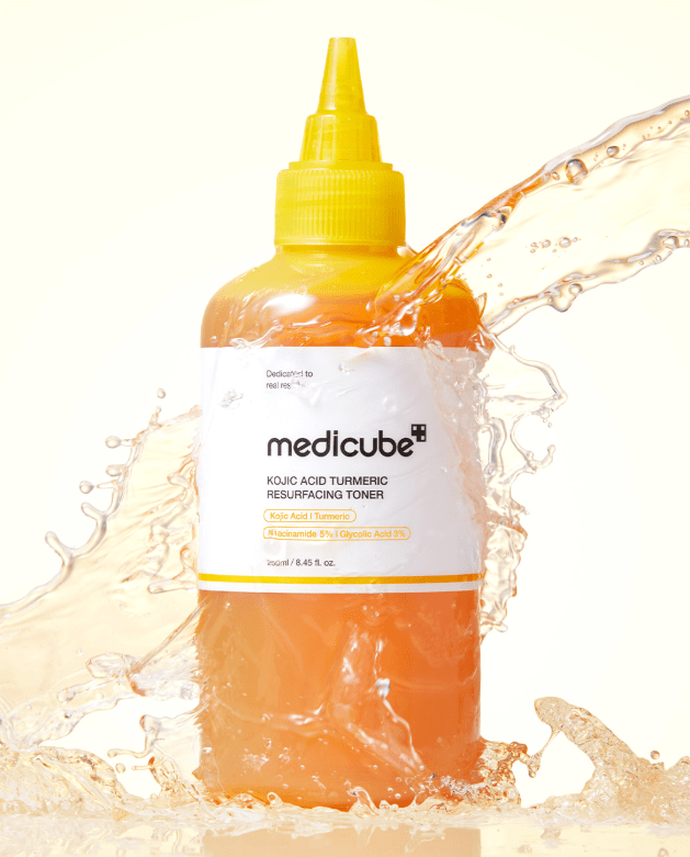 medicube Kojic Acid Turmeric Resurfacing Toner 250ml in vibrant orange bottle, brightening effect, clear splash background