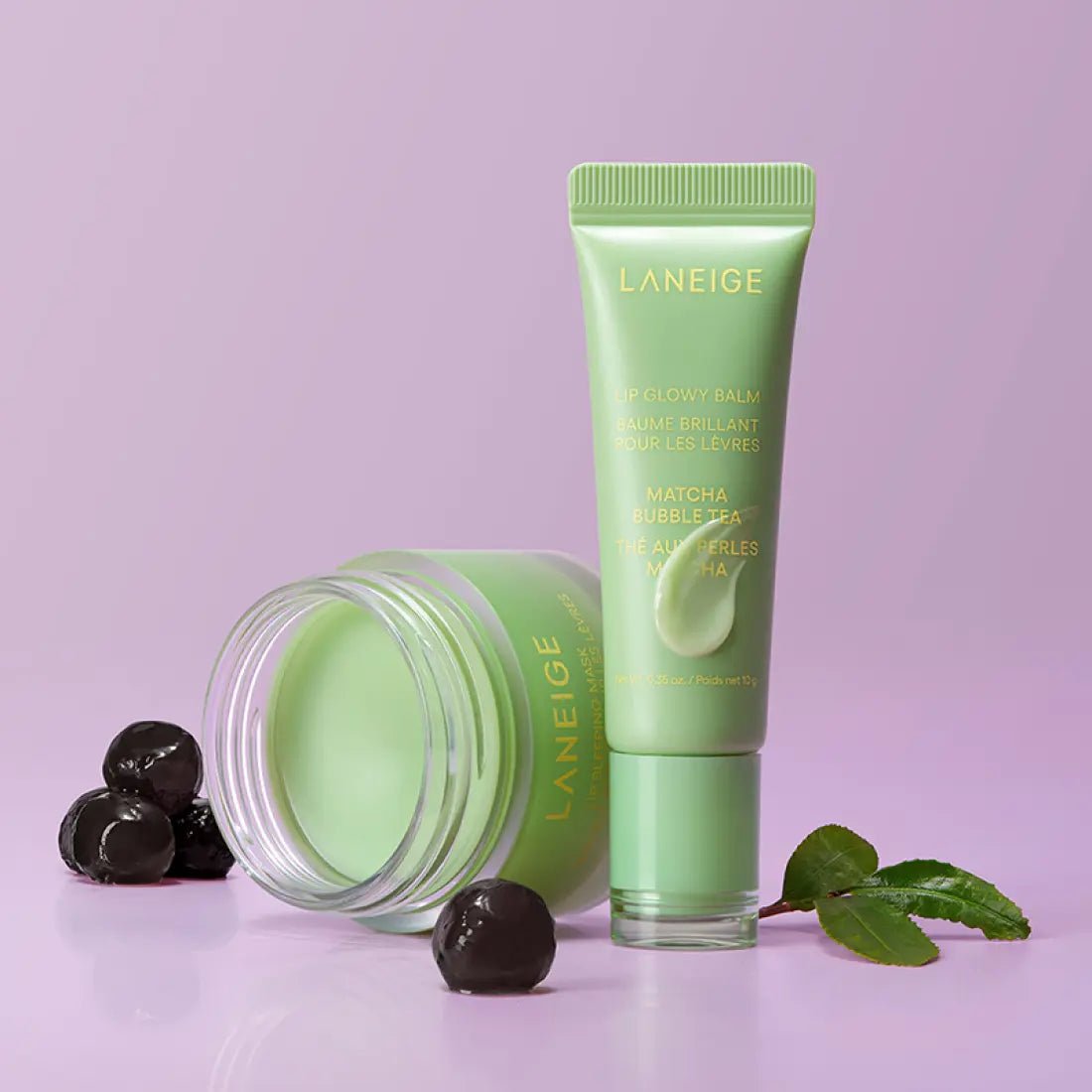 LANEIGE LIP GLOWY BALM 10ml #Matcha Bubble Tea in pastel green tube with hydration boost on light purple background