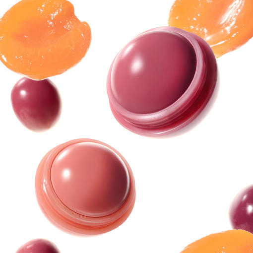 Lip balm containers in various colors on a white background