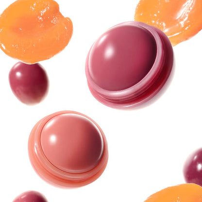 Lip balm containers in various colors on a white background