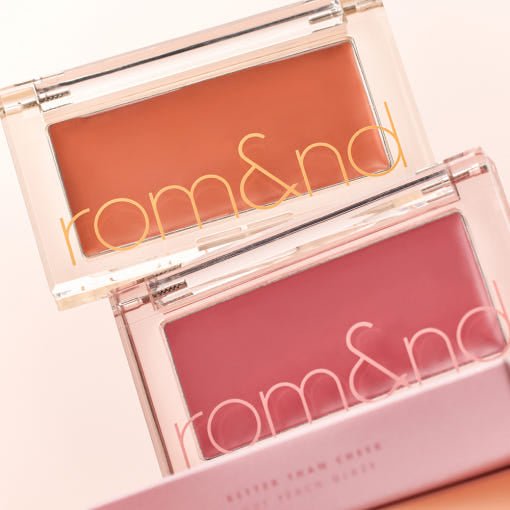 Two compact cream blushes in warm terracotta and muted rose shades with smooth texture in clear cases.