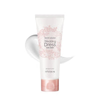 White tube of Wedding Dress pure cream with delicate pink floral design and pink cap, shown with smooth cream swatch behind