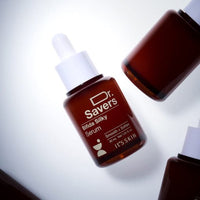 Brown glass bottle of silky serum with white dropper cap highlighting smooth and softened skin benefits on white background