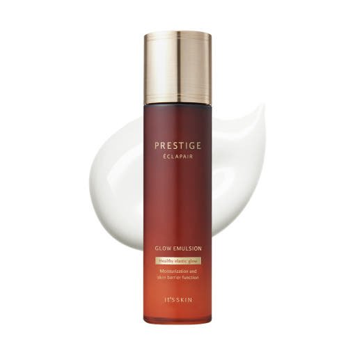 Tall frosted amber bottle with gold cap containing nourishing glow emulsion against white creamy background swirl