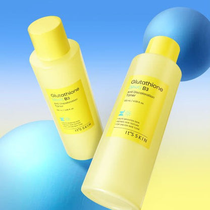 Two yellow plastic bottles of brightening anti discoloration toner with blue spherical props on gradient background