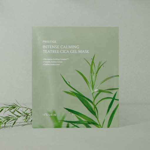 Matte sage green sachet of calming tea tree cica gel mask with leafy botanical illustration on soft background