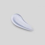 Light lavender tinted cream swatch with smooth glossy texture on a neutral gray background