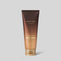 Brown gradient tube of Prestige Eclapair Glow Cleanser emphasizing thorough cleansing and healthy glow effect