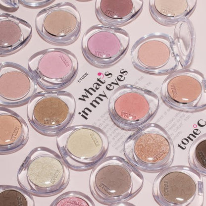 ETUDE What's In My Eyes 2g (29 Colors) eyeshadows in diverse vibrant shades with clear round packaging on soft pink background