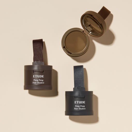 Three ETUDE Pang Pang Hair Shadow 3.5g containers with natural appearance shades on beige background