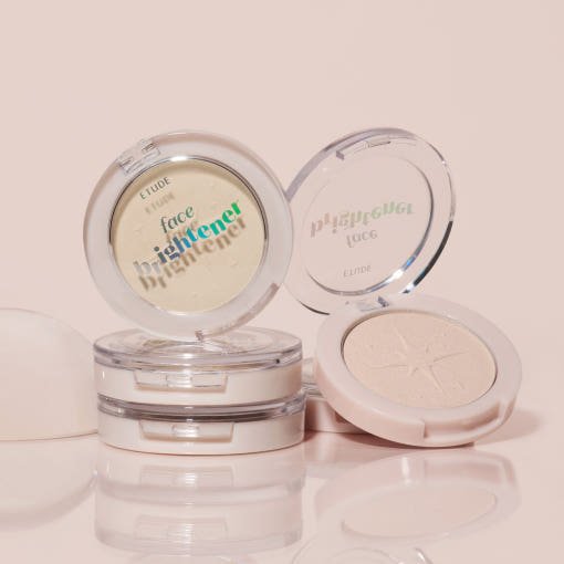 ETUDE Face Brightner 5g compact with natural highlight effect in sleek translucent packaging on beige surface