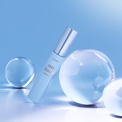 ETUDE My Lash Serum 18g with sleek silver cap and clear droplets on glossy blue surface highlighting lash strengthening benefits