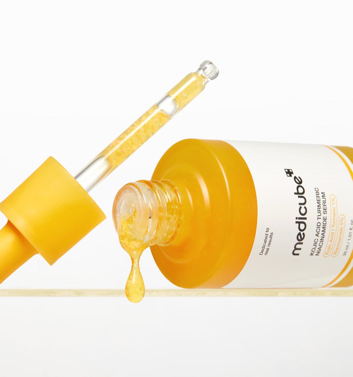 medicube Kojic Acid Turmeric Niacinamide Serum 30ml with dropper releasing golden brightening serum liquid