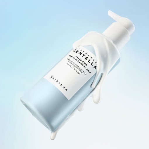 Light blue pump bottle of gentle cleansing milk with creamy texture on soft blue background for hydration benefits
