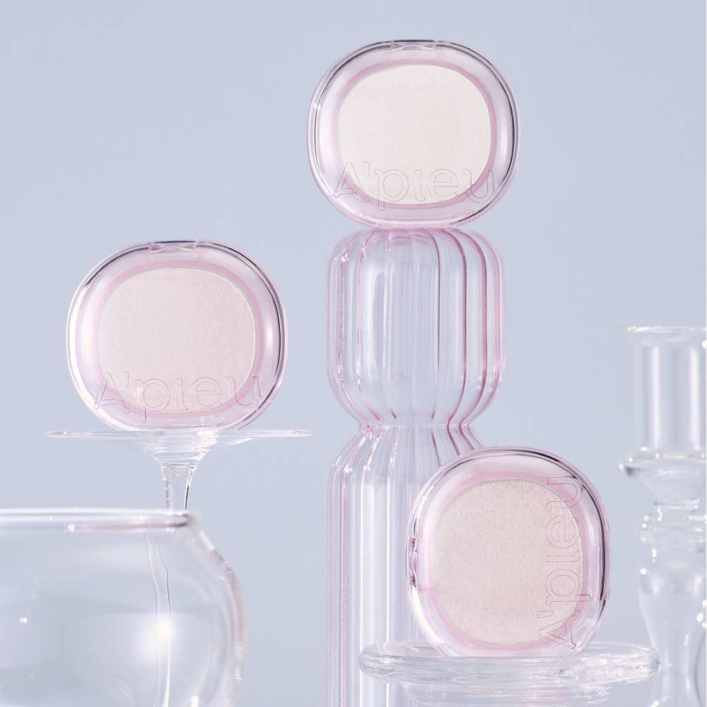 A'pieu Juicy Pang Gleaming Highlighter 4.7g (2 Colors) in translucent pink cases providing a soft translucent glow