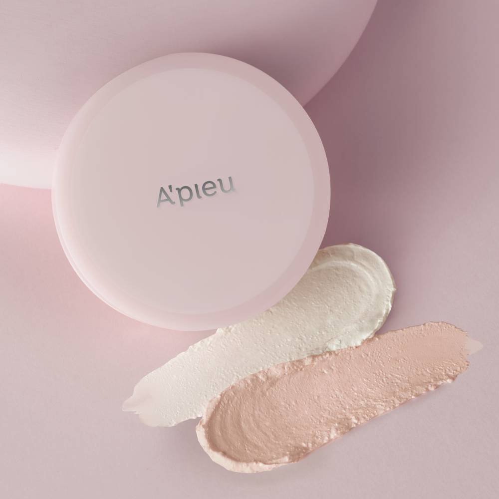 A'pieu Waterlock Skincare Primer Pink 14.7g compact with light beige and soft pink primer smears on pink surface