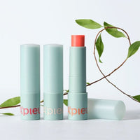 A'pieu Juicy Pang Care Lip Balm 3.7g (3 Colors) in pastel blue tubes with coral balm and green leaf background