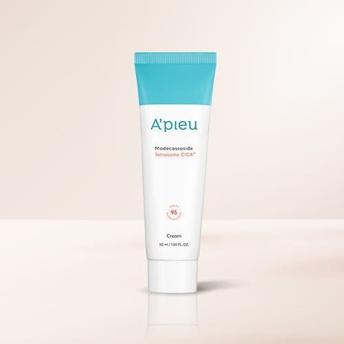 A'pieu Madecassoside Tetrasome CICA Cream 50ml white tube with blue cap offering intensive hydration on light beige background