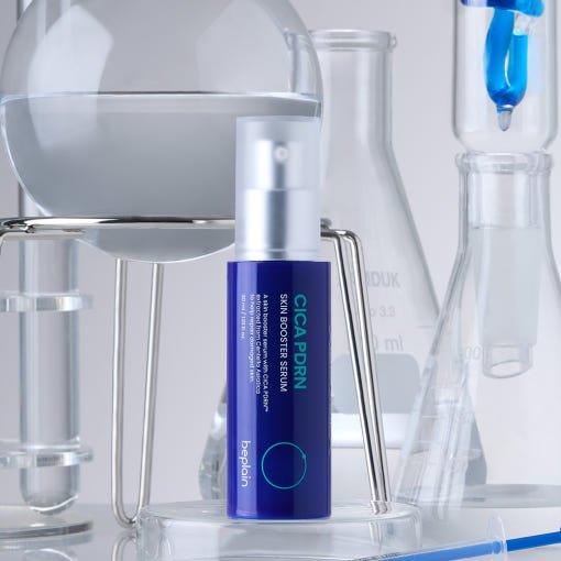 beplain CICA PDRN Skin Booster Serum 30ml in blue bottle with pump for barrier repair placed among clear lab glassware