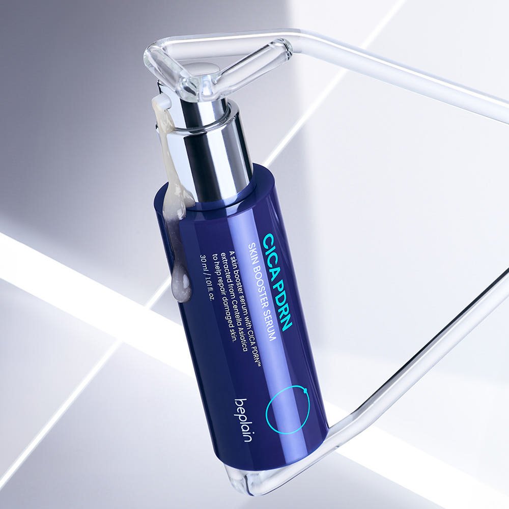 beplain CICA PDRN Skin Booster Serum 30ml in blue bottle with silver pump for barrier repair on reflective surface