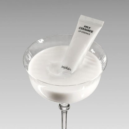 beplain Milk Ceramide Lip Essence 10g white tube immersed in creamy white liquid for intensive hydration care
