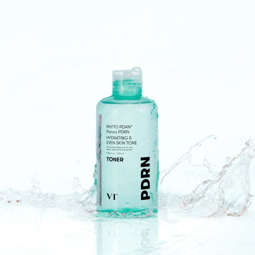 Clear aqua bottle of hydrating toner with water splash emphasizing skin tone brightening and moisture benefits