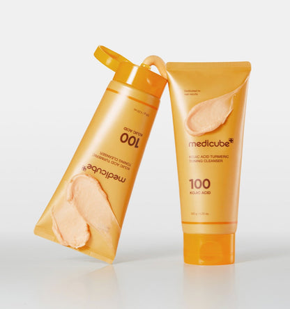 medicube Kojic Acid Turmeric Toning Cleanser 120g in orange tubes with creamy textured swatches showcasing brightening effect
