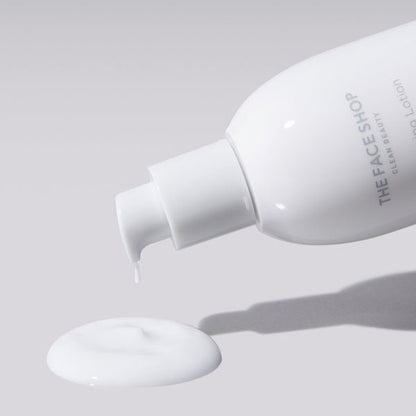 White lotion being dispensed from sleek white pump bottle with smooth lightweight skincare texture on gray background