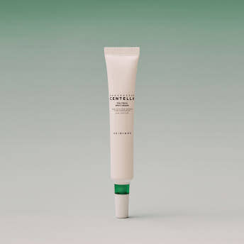 Minimalist beige tube of calming spot cream with green cap on soft gradient green background