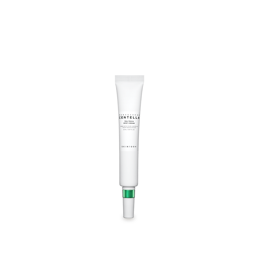 Slim white tube of calming spot cream with green accent cap for targeted skin soothing care